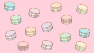 マカロンが散りばめられたピンクの背景画像
