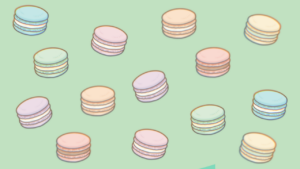 マカロンが散りばめられた緑色の背景画像